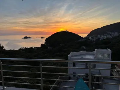 a sunset from the balcony of a building at Villa Nova Premium Apartment No 8 in Petrovac na Moru