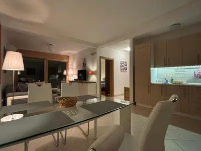 a kitchen and living room with a table and chairs at Villa Nova Premium Apartment No 8 in Petrovac na Moru