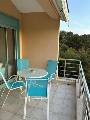 a patio with a table and chairs on a balcony at Villa Nova Premium Apartment No 8 in Petrovac na Moru