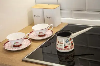 two cups and saucers sitting on a kitchen counter at Montenegrina apartment in Cetinje