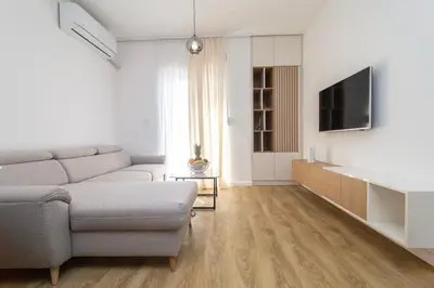 a living room with a couch and a tv at Montenegrina apartment in Cetinje