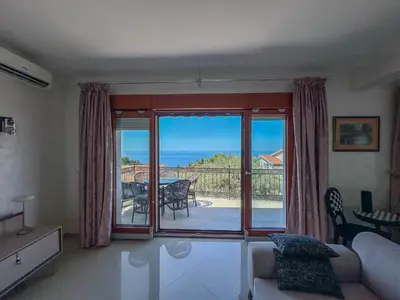 a living room with a view of the ocean at Olive Residence Rezevici in Budva