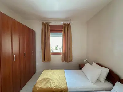 a small bedroom with a bed and a window at Olive Residence Rezevici in Budva