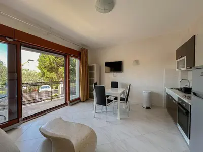 a kitchen and dining room with a table and chairs at Olive Residence Rezevici in Budva