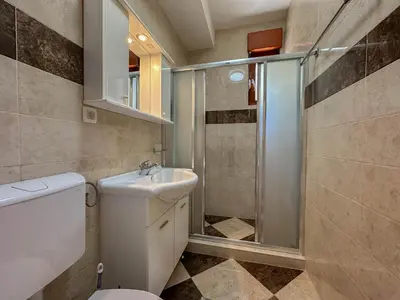 a bathroom with a toilet and a sink and a shower at Olive Residence Rezevici in Budva
