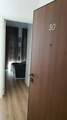 a door in a room with a bed in a bedroom at Porat Apartmani in Ulcinj
