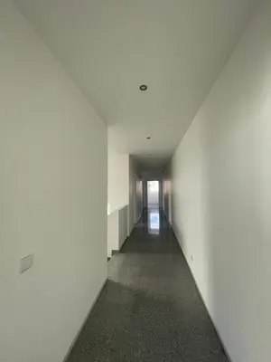 an empty hallway with white walls and a long corridor at Casa Klei in Ulcinj