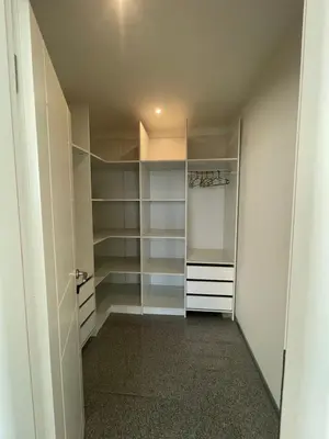 a walk in closet with white cabinets and shelves at Casa Klei in Ulcinj