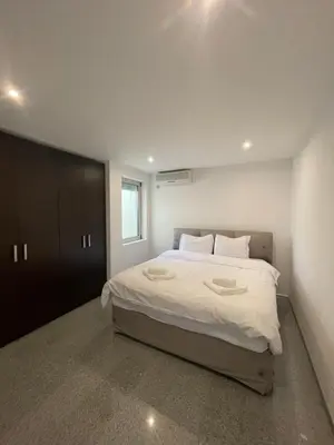 a bedroom with a large bed with white sheets at Casa Klei in Ulcinj