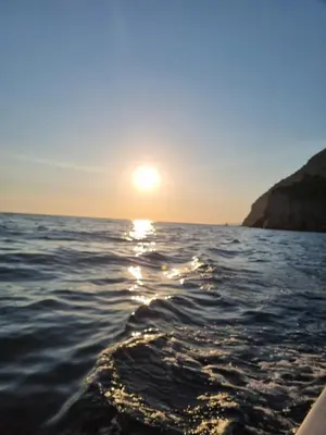 a sun setting over the ocean on a boat at Apartman-Studio Matanović- Save Kovačevića in Sutomore