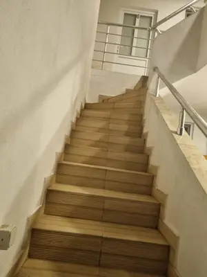 a staircase in a building with wooden floors at Apartman-Studio Matanović- Save Kovačevića in Sutomore