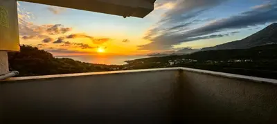 a view of a sunset from a balcony at Plavi Horizont in Utjeha