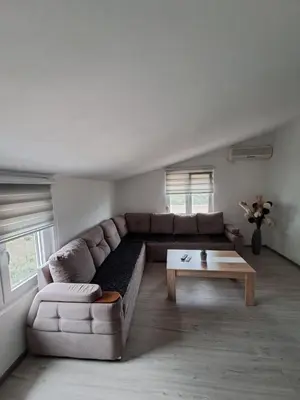a living room with a couch and a coffee table at Plavi Horizont in Utjeha