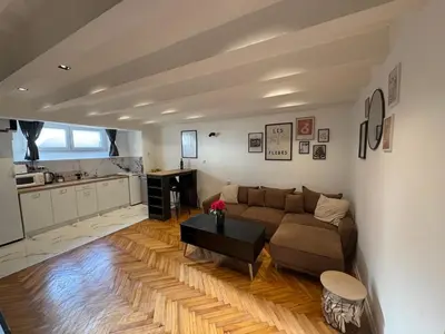 a living room with a couch and a table at Matija Urban Suits- Downtown in Podgorica