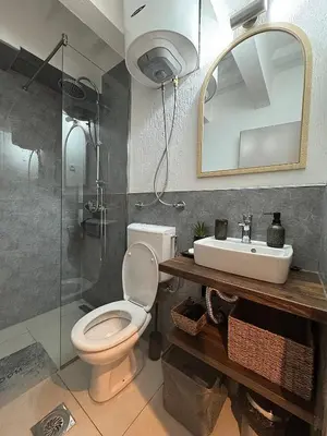 a bathroom with a toilet and a sink and a mirror at Matija Urban Suits- Downtown in Podgorica