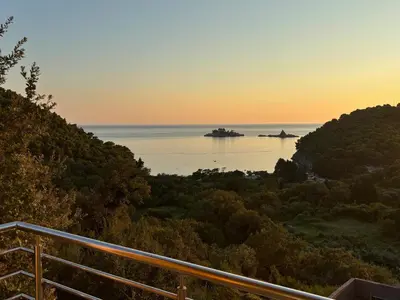 a view of the ocean at sunset from a balcony at Villa Nova Premium Apartment No 5 in Prijevorac