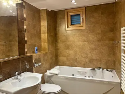 a bathroom with a tub and a toilet and a sink at Villa Nova Premium Apartment No 5 in Prijevorac
