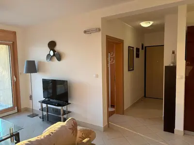 a living room with a couch and a tv at Villa Nova Premium Apartment No 5 in Prijevorac