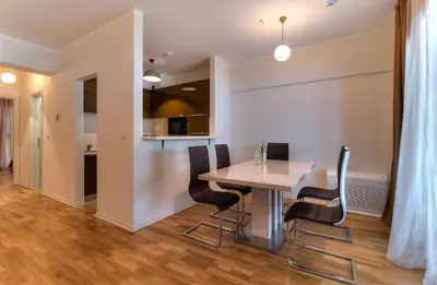 a dining room with a table and chairs at Sea View Apartments MonteBook in Becici