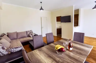 a living room with a table and a couch at Sea View Apartments MonteBook in Becici
