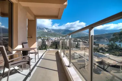a balcony with a view of a city and mountains at Sea View Apartments MonteBook in Becici