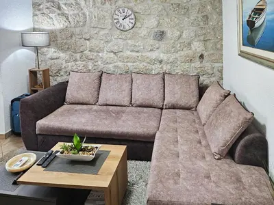 a living room with a couch and a table at Holiday House Kotor in Kotor