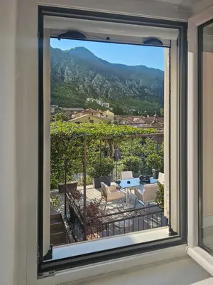 a window with a view of a patio at Holiday House Kotor in Kotor