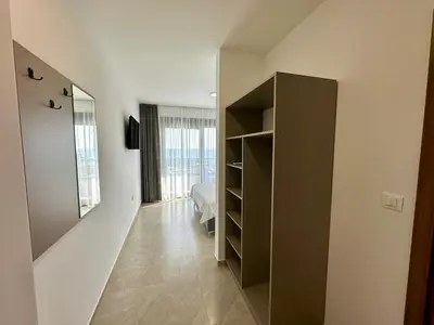 a bedroom with a book shelf and a bed at Apartmani Kojić 2 in Bar, Susanj