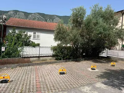 three small yellow helmets on a brickickedicked yard at Megy Apartment with parking and sea view in Kotor