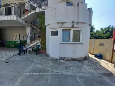 a building with a white door and a balcony at Apartmani Todorović in Bar