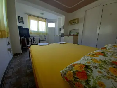 a bedroom with a large yellow bed in a room at Apartmani Todorović in Bar