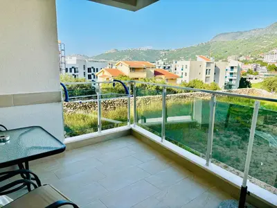 a balcony with a view of a city at Mira Apartment in Dobra Voda