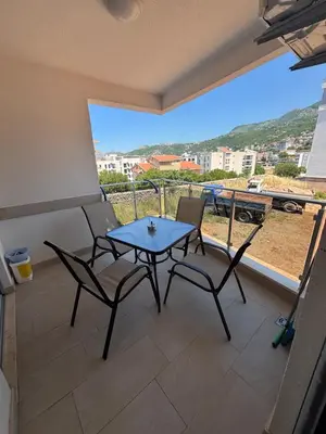 a table and chairs on a balcony with a view at Mira Apartment in Dobra Voda