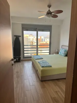 a bedroom with a bed and a large window at Hana Apartments in Dobra Voda