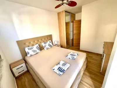 a bedroom with a bed with two pillows on it at Hana Apartments in Dobra Voda
