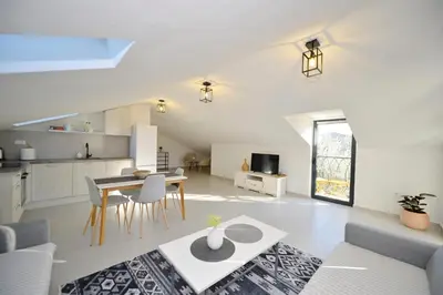 a kitchen and living room with a table and chairs at Green Ranch Stara Maslina in Kotor