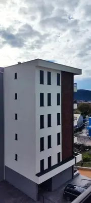 a white building with black windows on top of it at Sweet Escape in Bar