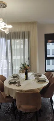 a dining room table with chairs and a table cloth at Sweet Escape in Bar