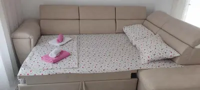 a couch with two pink pillows on it at Sweet Escape in Bar