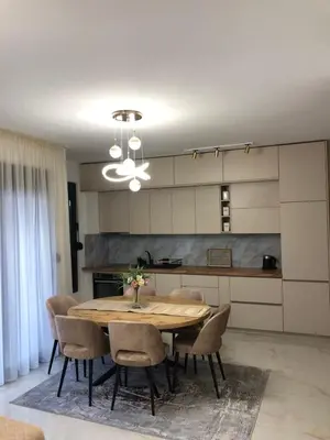 a kitchen with a dining room table and chairs at Sweet Escape in Bar