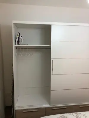 a white closet with white drawers and a shelf at Sweet Escape in Bar