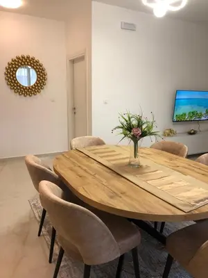 a dining room with a wooden table and chairs at Sweet Escape in Bar