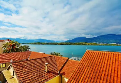 a view of a large body of water with mountains at Apartments Bella di Boka in Tivat