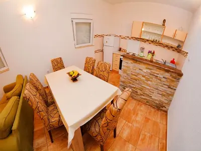 a kitchen with a table and chairs in a room at Apartments Bella di Boka in Tivat