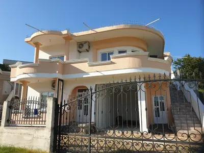 a house with a gate in front of it at CC Apartments in Ulcinj