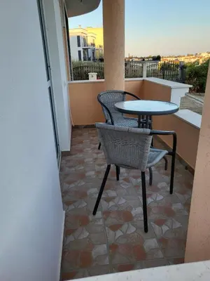 a patio with a table and chairs on a balcony at CC Apartments in Ulcinj