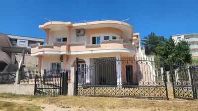 a house with a gate and a fence at CC Apartments in Ulcinj