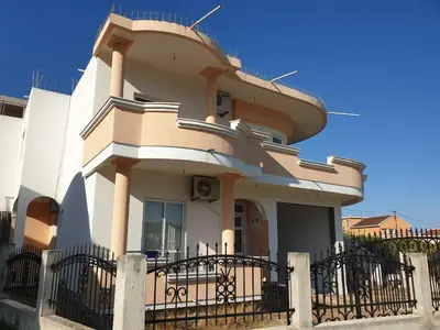 a building with a fence in front of it at CC Apartments in Ulcinj