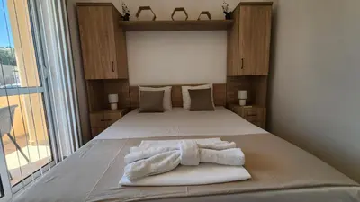 a bedroom with a bed with towels on it at CC Apartments in Ulcinj