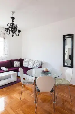 a dining room with a glass table and chairs at Apartment Taurus in Petrovac na Moru